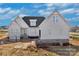 New construction exterior with white siding, brick foundation, and ladder leaning on the right at 2059 Parks Rd, Salisbury, NC 28147