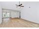 Bright, spacious living area featuring a large window, wood floors, and modern ceiling fan at 2059 Parks Rd, Salisbury, NC 28147