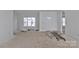 Spacious room with a large window and white walls awaiting finishing touches. Ladders on floor at 2059 Parks Rd, Salisbury, NC 28147