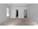 Spacious room with two door openings and a window allowing natural light, ready for personal touches at 2059 Parks Rd, Salisbury, NC 28147