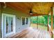 Relax on the covered back porch with a wood ceiling and fan while enjoying the outdoor views at 2640 Ironwood Dr, Hickory, NC 28602
