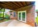 A concrete covered patio showcasing brickwork walls and a double door entry to home at 2640 Ironwood Dr, Hickory, NC 28602