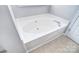 Clean bathroom featuring a large soaking tub and neutral tile flooring at 217 Dewars Dr, Rock Hill, SC 29730