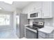 Updated kitchen with stainless steel appliances, white cabinets, and stylish backsplash at 217 Dewars Dr, Rock Hill, SC 29730