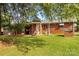 View of brick home's backyard with covered patio and mature trees at 5960/5930 S Main St, Salisbury, NC 28147