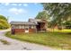 View of brick home's backyard featuring a small brick shed at 5960/5930 S Main St, Salisbury, NC 28147