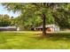 Expansive backyard featuring green lawn and mature trees for shade and privacy at 5960/5930 S Main St, Salisbury, NC 28147