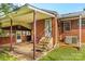 Brick home's backyard featuring covered patio and steps to the back door at 5960/5930 S Main St, Salisbury, NC 28147