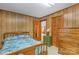 Bedroom features paneled walls, a dresser, and a door leading to another room at 5960/5930 S Main St, Salisbury, NC 28147