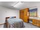 Bedroom features a built-in wardrobe and desk alongside a comfortable bed and natural light at 5960/5930 S Main St, Salisbury, NC 28147
