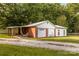 Single-story home featuring a brick chimney and a convenient car port at 5960/5930 S Main St, Salisbury, NC 28147