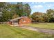 Brick home's exterior featuring ramp access and verdant lawn, surrounded by trees at 5960/5930 S Main St, Salisbury, NC 28147
