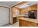 Functional kitchen featuring wooden cabinets, black appliances, and a breakfast bar at 5960/5930 S Main St, Salisbury, NC 28147