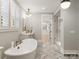Spa-like bathroom featuring a soaking tub, walk-in shower, and ample closet space at 8115 Farm Crossing Ln # 3, Huntersville, NC 28078