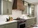 Modern kitchen with green cabinets and a wooden range hood at 8115 Farm Crossing Ln # 3, Huntersville, NC 28078