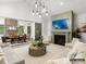 Spacious living room features a fireplace and opens to a sunroom and dining area at 8115 Farm Crossing Ln # 3, Huntersville, NC 28078