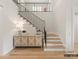 Elegant staircase with a modern metal railing and hardwood steps at 8115 Farm Crossing Ln # 3, Huntersville, NC 28078