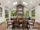 Sunroom with stone fireplace, dining area, and ample natural light at 8115 Farm Crossing Ln # 3, Huntersville, NC 28078