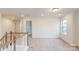 Bright bedroom featuring plush carpeting and multiple windows offering scenic views of the neighborhood at 649 Kitfox Nw Dr, Concord, NC 28027