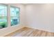 Bright room showcasing light wood flooring and large windows, offering ample natural light at 649 Kitfox Nw Dr, Concord, NC 28027