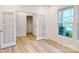 Bright room showcasing light wood flooring, large windows, and french doors at 649 Kitfox Nw Dr, Concord, NC 28027