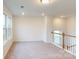 Bright bedroom featuring plush carpeting and multiple windows offering scenic views of the neighborhood at 649 Kitfox Nw Dr, Concord, NC 28027