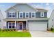 Charming two-story home featuring a two-car garage, covered porch, and well-maintained landscaping at 649 Kitfox Nw Dr, Concord, NC 28027