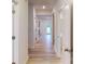Bright hallway featuring light wood flooring and white doors leading to various rooms at 649 Kitfox Nw Dr, Concord, NC 28027