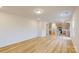 Open-concept living space connecting the living room to the modern kitchen with light wood flooring at 649 Kitfox Nw Dr, Concord, NC 28027