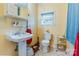 Clean bathroom with pedestal sink, toilet, and shower at 713 Perkins St, Lowell, NC 28098