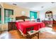 Main bedroom with red bedding and wood floors at 713 Perkins St, Lowell, NC 28098