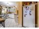 Kitchen with white cabinets and a large refrigerator at 713 Perkins St, Lowell, NC 28098