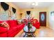 Bright living room featuring red couch and wood floors at 713 Perkins St, Lowell, NC 28098