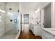 Well-lit bathroom featuring a dual sink vanity and glass-enclosed shower with marble tiling at 2025 Parks Rd, Salisbury, NC 28147