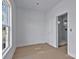 A bathroom leading to a shower area with a window providing natural light at 2025 Parks Rd, Salisbury, NC 28147