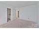 Bright bedroom featuring neutral walls, trim and two open doorways to other rooms in the home at 2025 Parks Rd, Salisbury, NC 28147