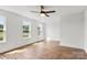 Light-filled bedroom with three windows, ceiling fan and hardwood floors at 2025 Parks Rd, Salisbury, NC 28147