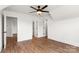 Bedroom with light wood flooring, ceiling fan, and white walls with several doors at 2025 Parks Rd, Salisbury, NC 28147