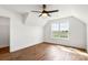 Bedroom features light wood flooring, a ceiling fan, and a window with an outdoor view at 2025 Parks Rd, Salisbury, NC 28147