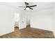 Bedroom shows neutral paint, ceiling fan, and view to bath and hall at 2025 Parks Rd, Salisbury, NC 28147