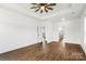 Spacious bedroom featuring a tray ceiling with fan and wood-look flooring at 2025 Parks Rd, Salisbury, NC 28147