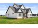 Exterior angle of house with black trim, white siding, gray roof and green lawn at 2025 Parks Rd, Salisbury, NC 28147