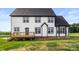 Back exterior of house with black trim windows and wooden porch and view of the yard at 2025 Parks Rd, Salisbury, NC 28147
