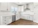 Modern kitchen featuring white cabinets, stainless steel appliances, and hardwood floors at 2025 Parks Rd, Salisbury, NC 28147
