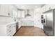 Bright kitchen with white cabinetry, stainless steel appliances, and stylish hardwood flooring at 2025 Parks Rd, Salisbury, NC 28147
