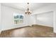 Inviting living space with wood floors, a modern light fixture, and a large window offering a scenic view at 2025 Parks Rd, Salisbury, NC 28147