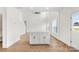 Open-concept living area showcasing wood floors, a kitchen island, white cabinets, and abundant natural light at 2025 Parks Rd, Salisbury, NC 28147