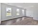 A well-lit living room showcases the wood flooring and natural light from the three windows at 2025 Parks Rd, Salisbury, NC 28147
