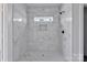 Modern shower featuring marble tiling, a built-in niche, and sleek fixtures at 2025 Parks Rd, Salisbury, NC 28147