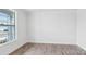 Bright bedroom with wood-look floors and a large window offering natural light at 317 Miramar Dr, York, SC 29745